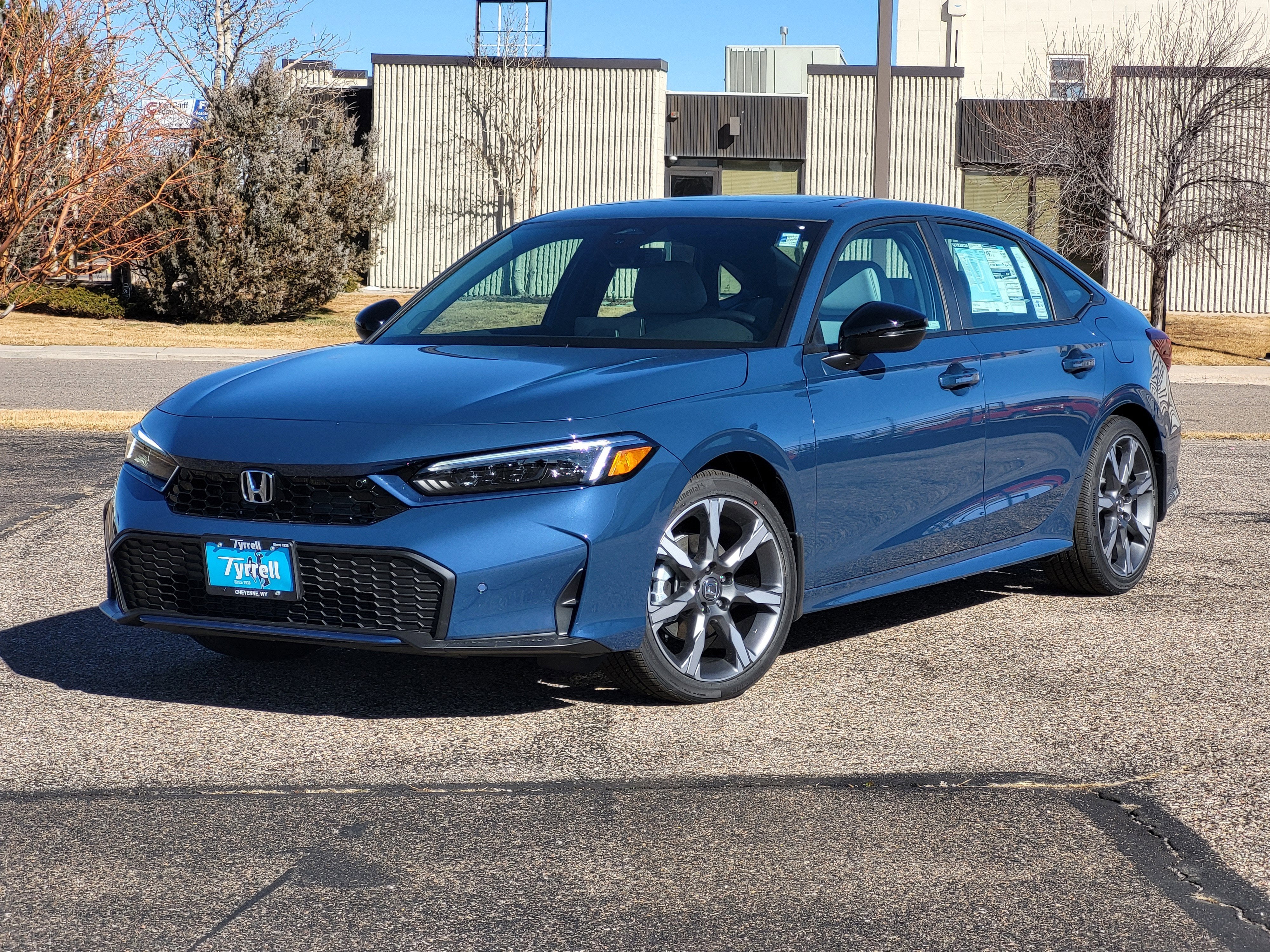 2026 Honda Civic Sedan Hybrid Sport Touring in Blue Lagoon Pearl — front three-quarter view